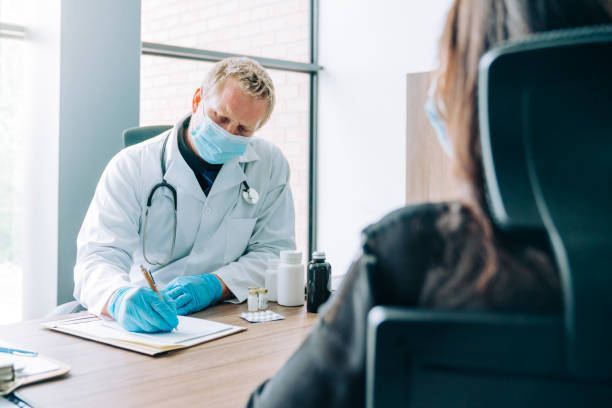 Gynecologic surgeon Dr. Arthur J. Grizzle, M.D., discussing a surgical procedure with a patient in Key West, FL.