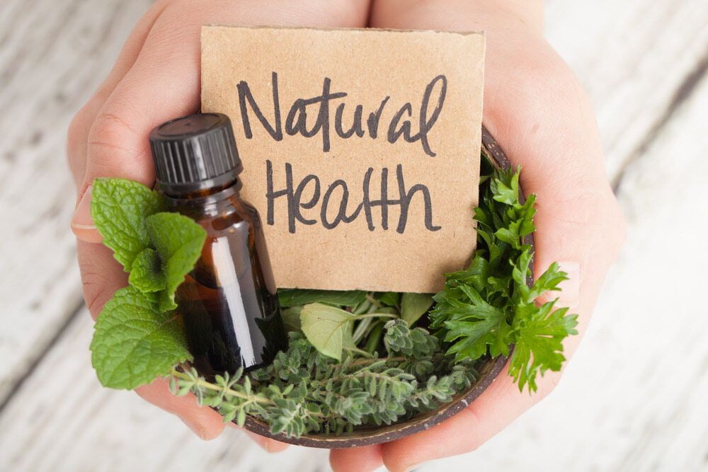 A Bowl of Herbs and a Bottle of Essential Oil — Anderson Family Chiropractic Health Centre in Mount Pleasant, QLD 