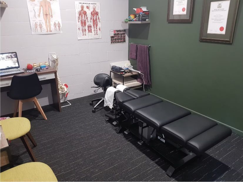 A Room With a Desk, Chairs, and a Couch — Anderson Family Chiropractic Health Centre in Mount Pleasant, QLD