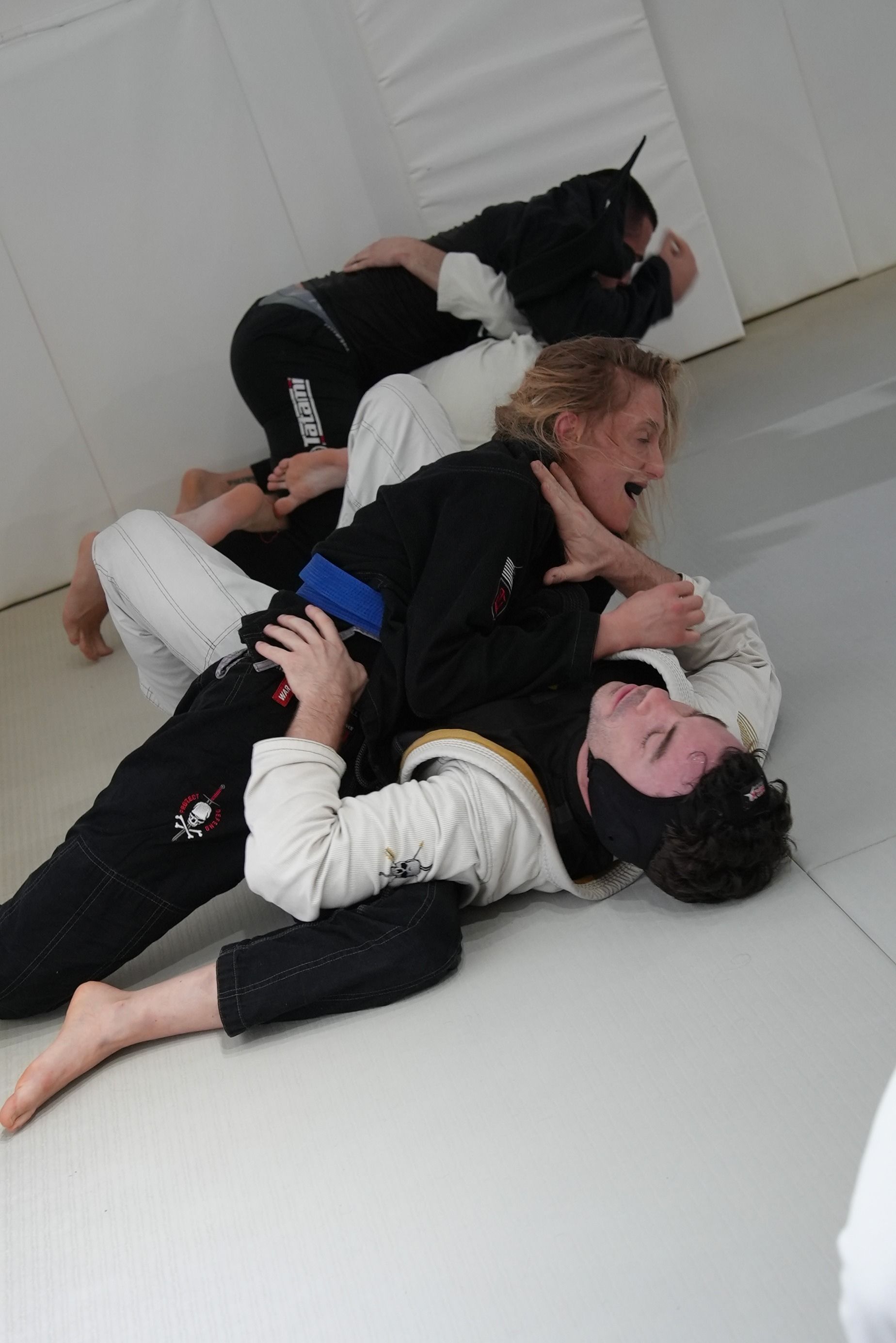 Adults drilling Brazilian Jiu-Jitsu techniques at Range Brazilian Jiu-Jitsu NYC in New York, NY for full-body fitness.