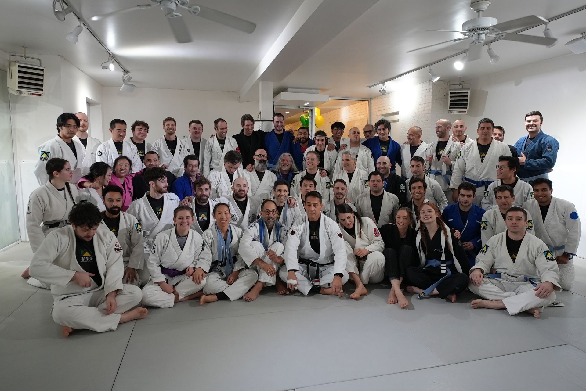 Adults drilling Brazilian Jiu-Jitsu techniques at Range Brazilian Jiu-Jitsu NYC in New York.