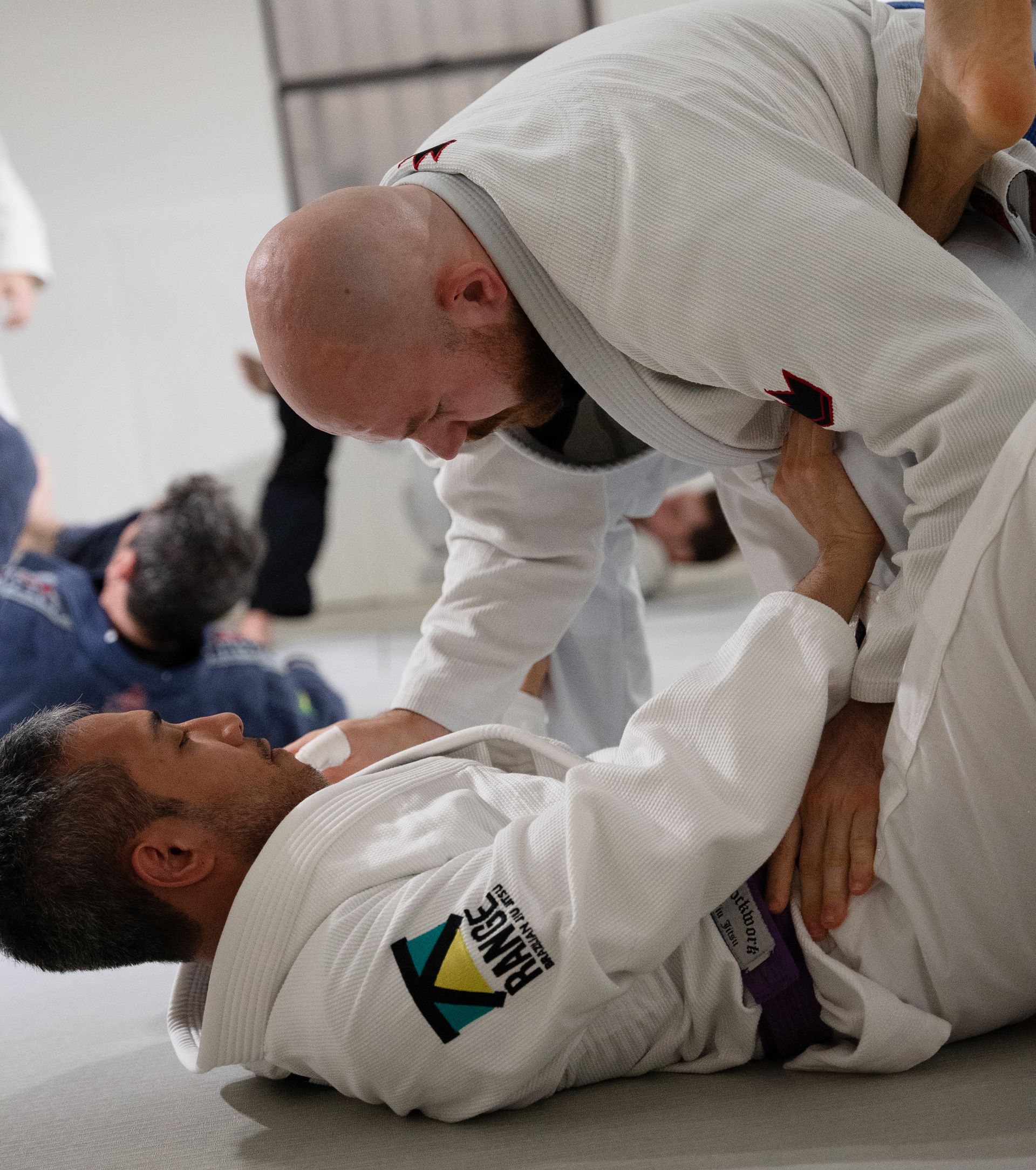 Adult students drilling Brazilian Jiu-Jitsu at Range Brazilian Jiu-Jitsu NYC in New York, NY for fitness and confidence.