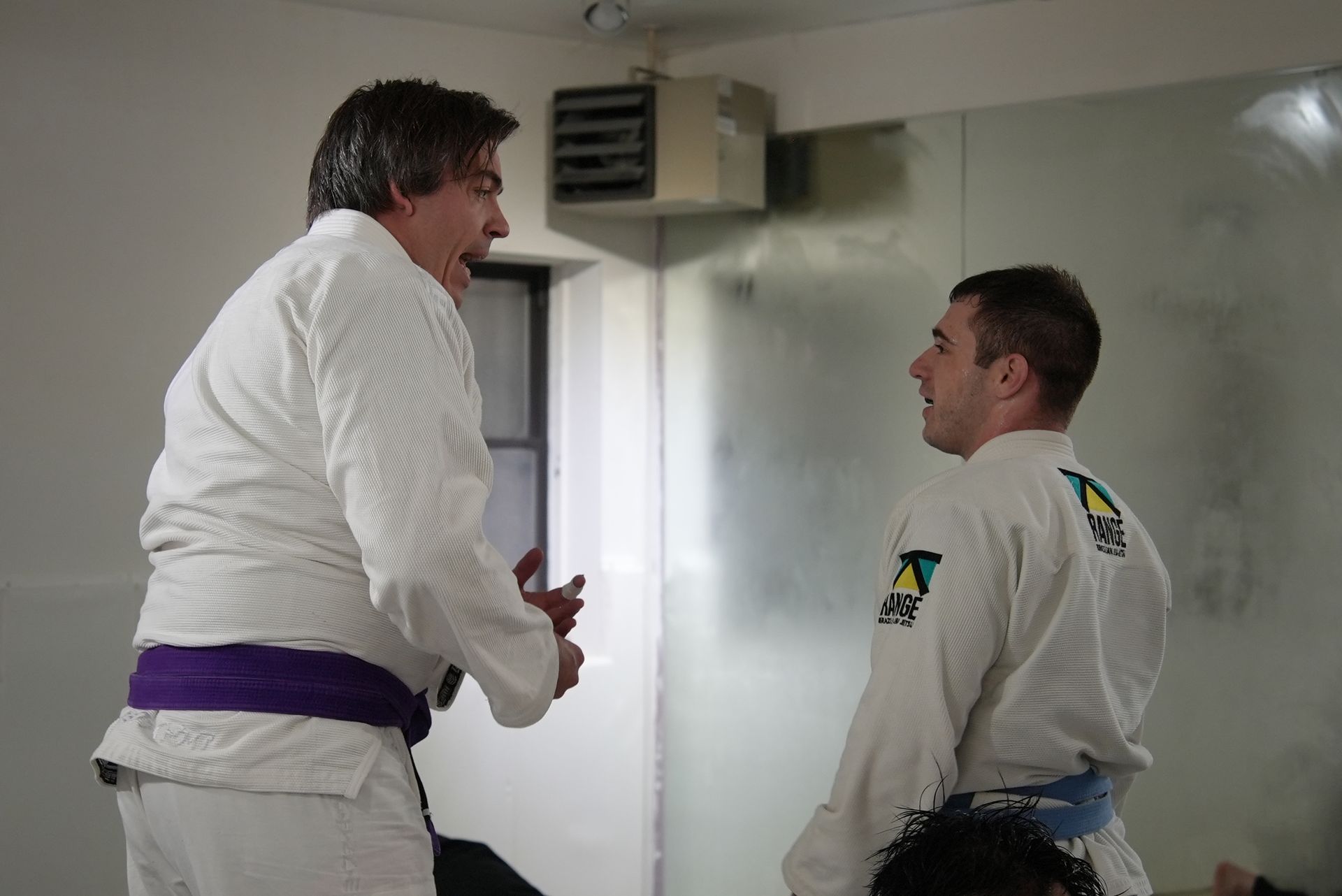 Students drilling Brazilian Jiu-Jitsu at Range Brazilian Jiu-Jitsu NYC in New York, NY, building calm focus.