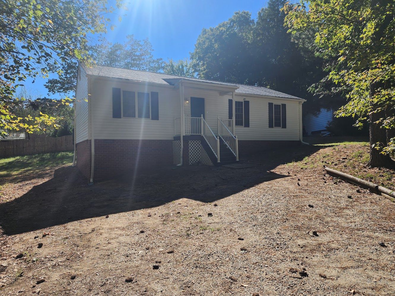 white starter home with brick foundation bought from a homebuying company in richmond