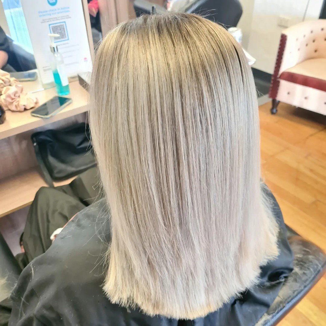 Blonde hair with natural roots showing.
