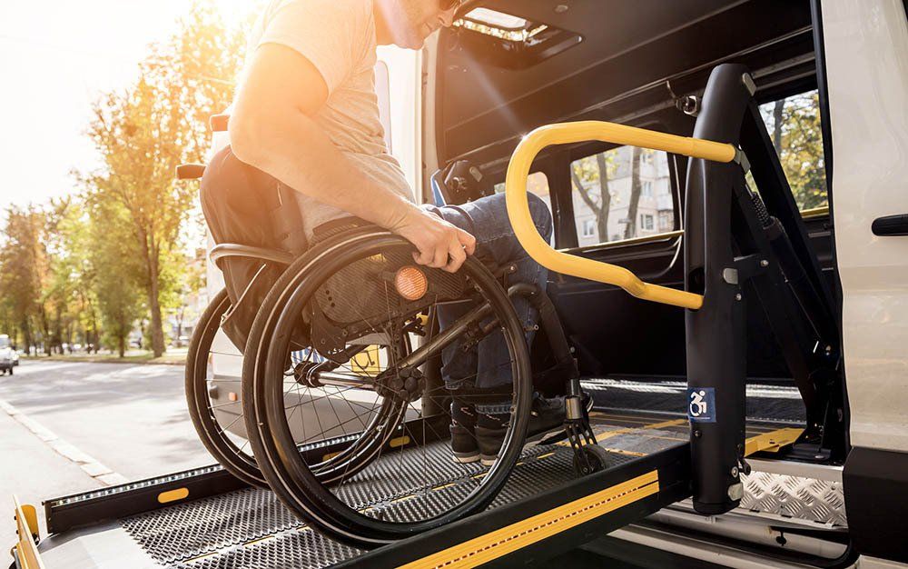 A Patient In Wheelchair Entering A Van — Bristol, TN — Ambulance Service of Bristol, Inc. A Patient In Wheelchair Entering A Van — Bristol, TN — Ambulance Service of Bristol, Inc.