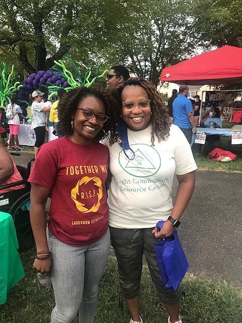 Two women are posing for a picture together in a park at a LCRC community event.