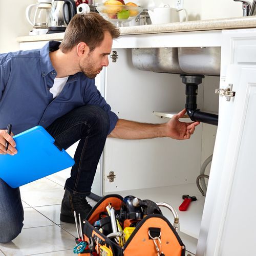 Plumber Doing Check and Maintenance on a Sink Pipe Plumber Doing Check and Maintenance on a Sink Pipe