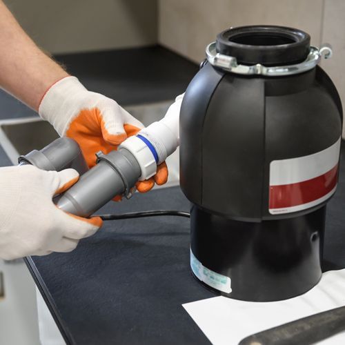 Plumber Preparing a Garbage Disposal Plumber Preparing a Garbage Disposal
