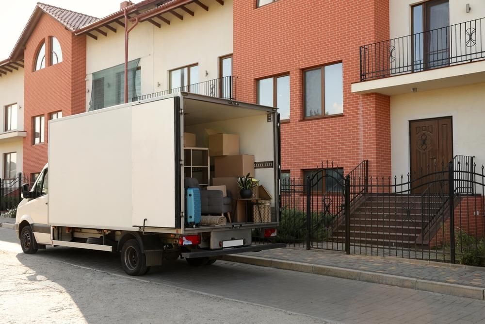A Moving Truck Is Parked In Front Of A House — Ahern's Removals In Brisbane, NSW, QLD