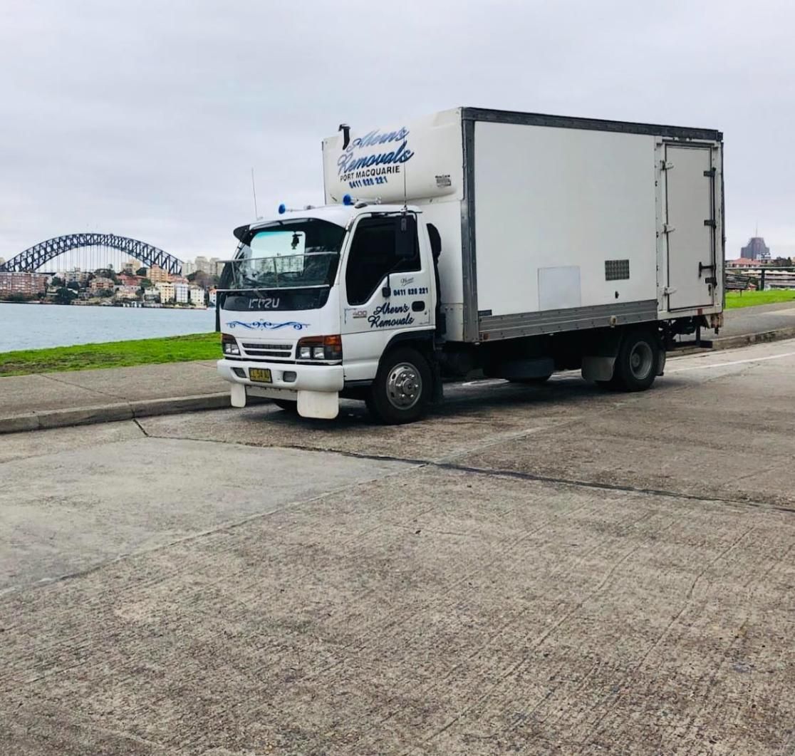 A White Truck Is Parked On The Side Of The Road — Ahern's Removals In Lake Cathie, NSW