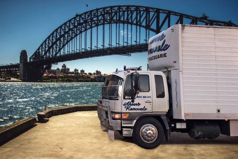 A White Truck Is Parked In Front Of A Bridge Over A Body Of Water — Ahern's Removals In Port Macquarie, NSW