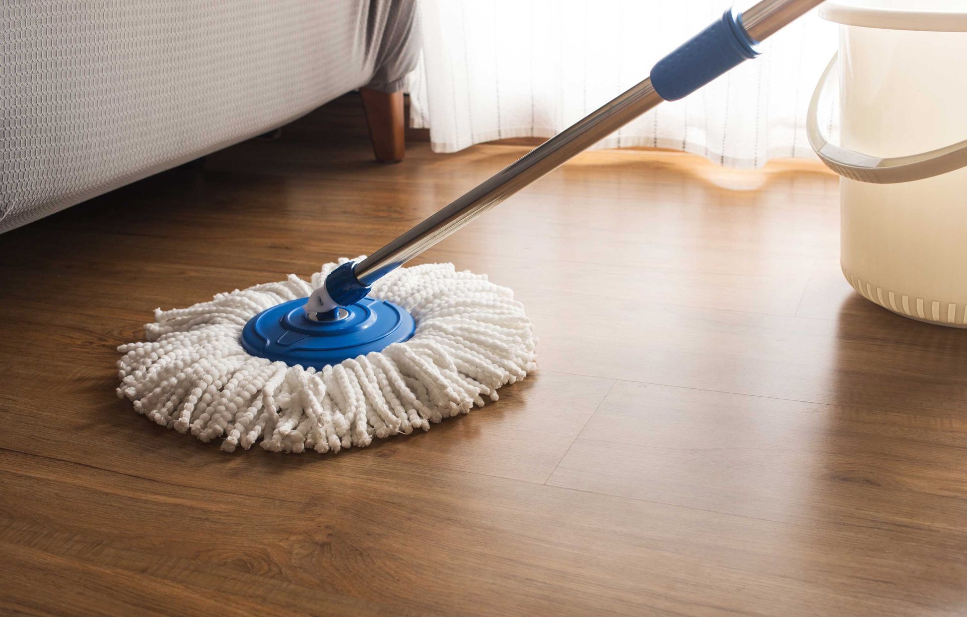 Mop cleaning on a wooden floor.