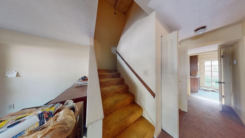 Water-damaged foyer with stained carpeting before restoration