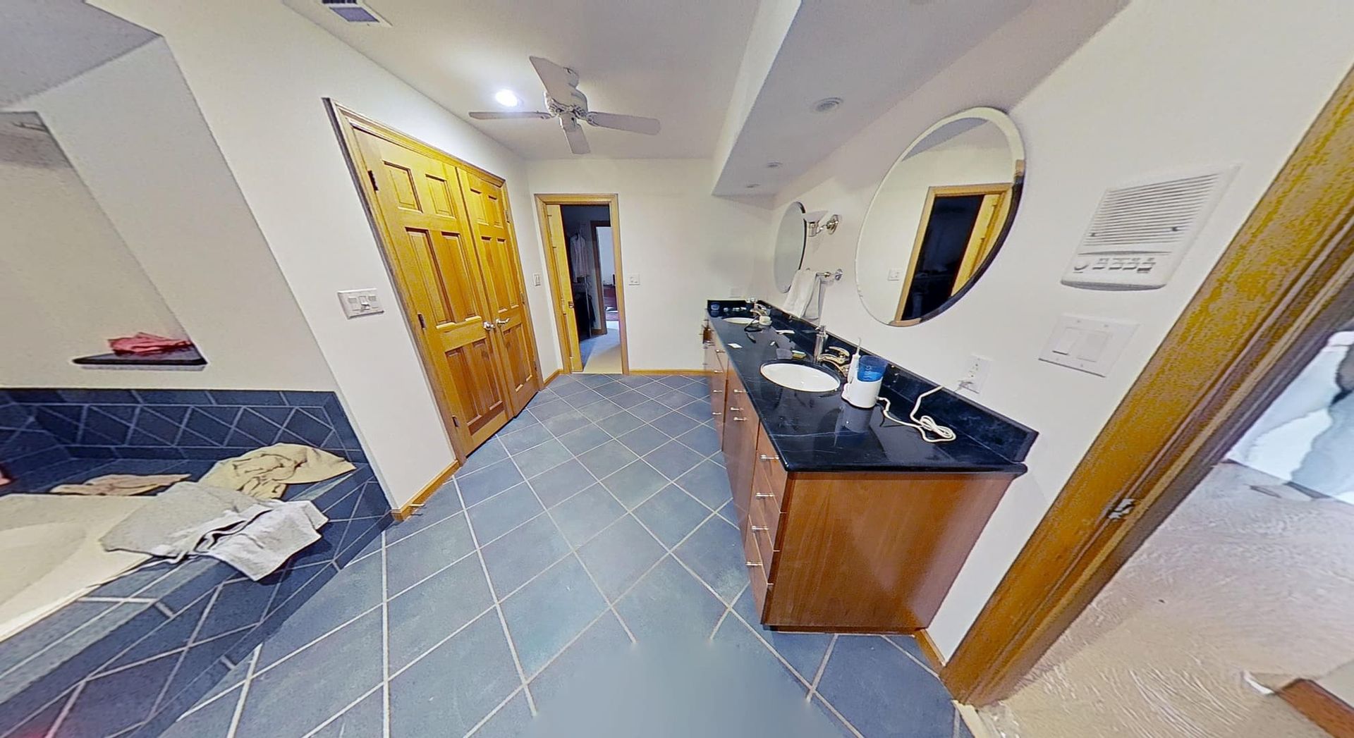 Restored bathroom ceiling after water damage repair, second angle
