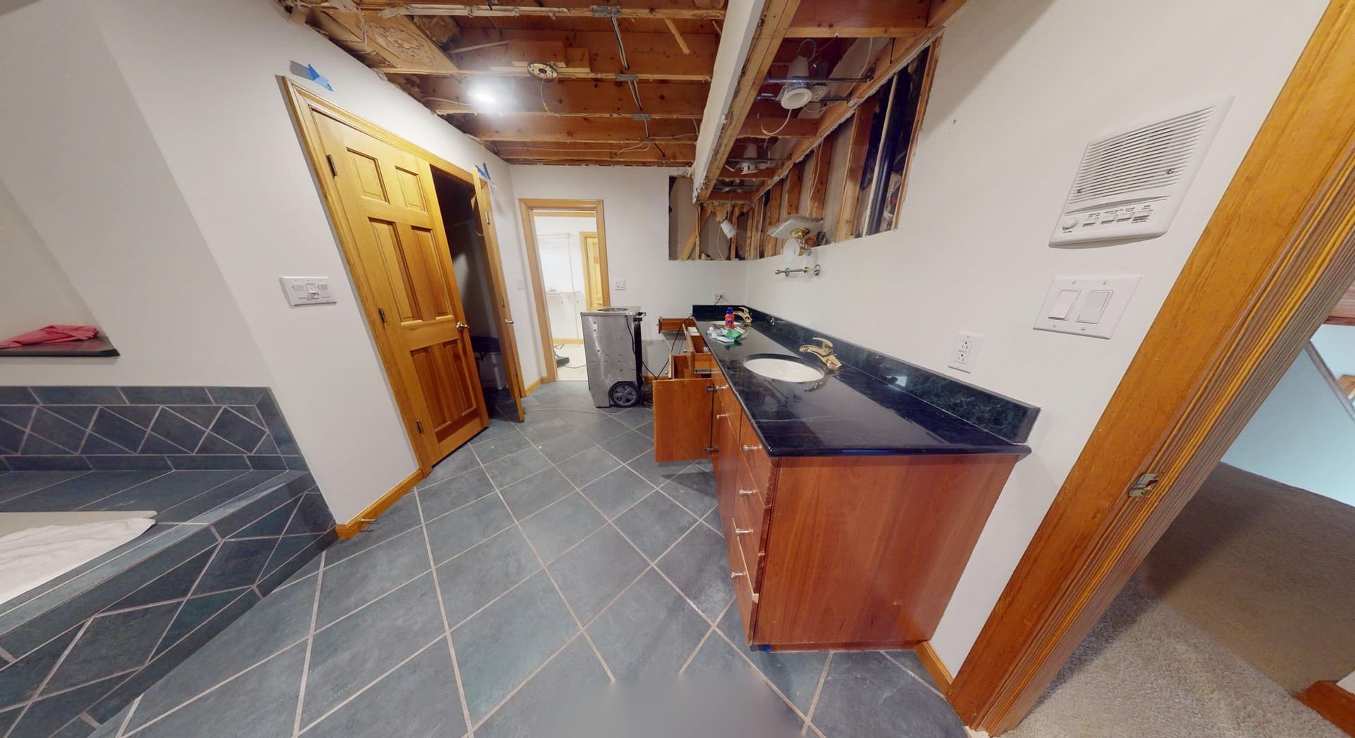 Bathroom ceiling water damage from another angle before restoration in Atlanta