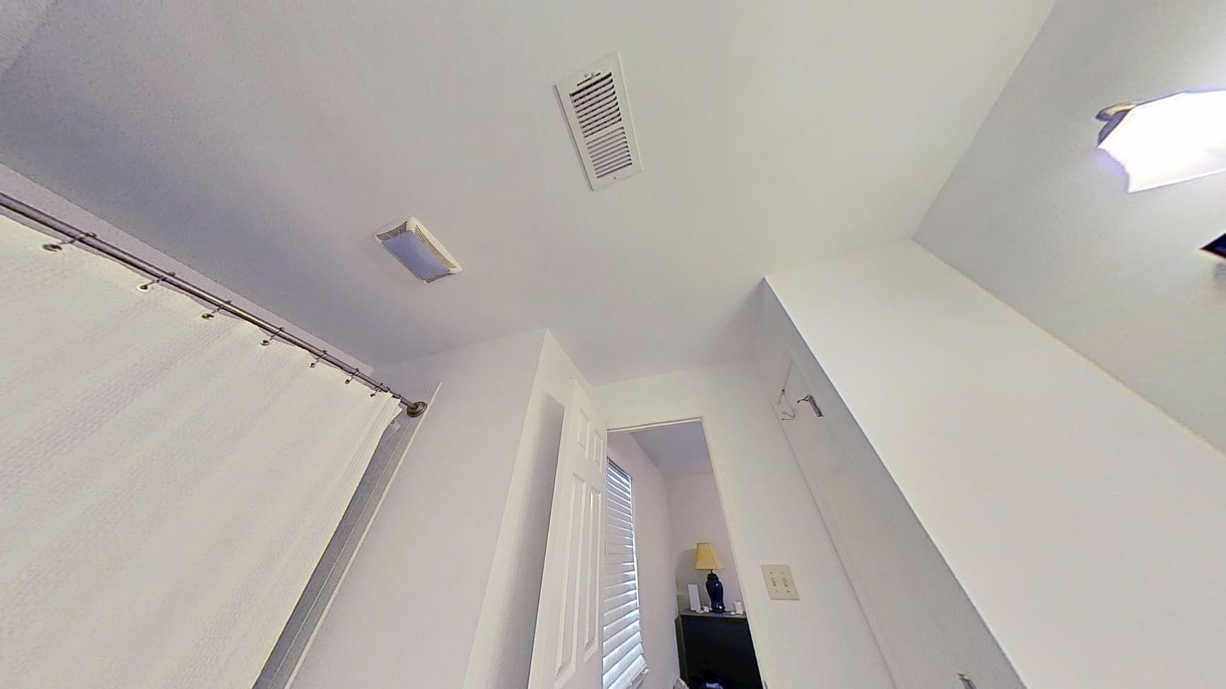 Repaired and repainted bathroom ceiling after water damage restoration by The Homestar Group