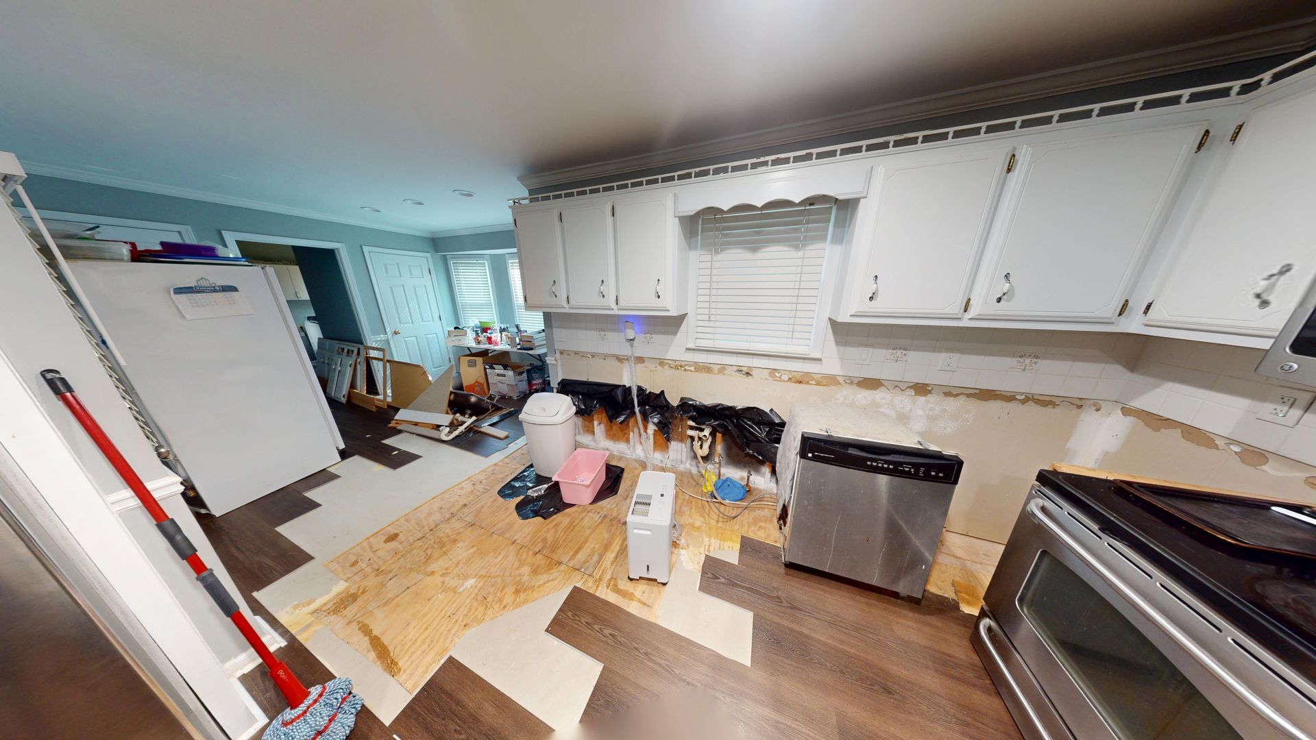 Close-up of water-damaged kitchen cabinet before repair