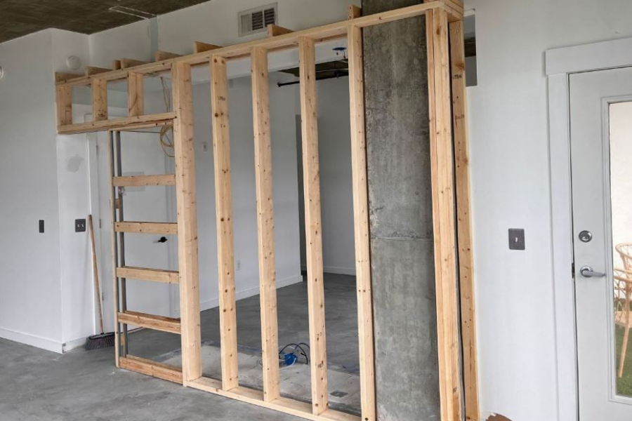 Drywall removal during professional water damage restoration showing moisture damage