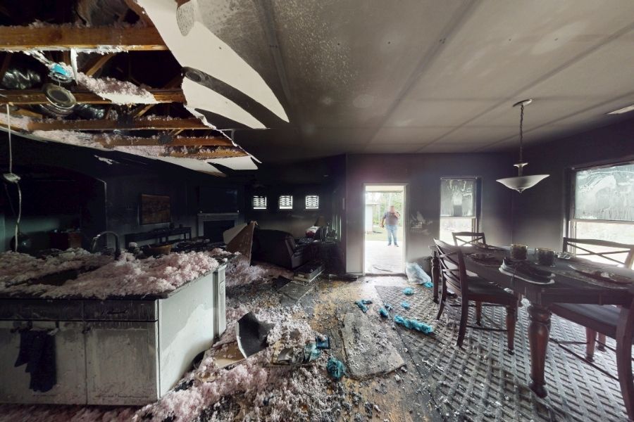 Extensive fire damage visible in an Atlanta home kitchen with charred cabinets and structural damage