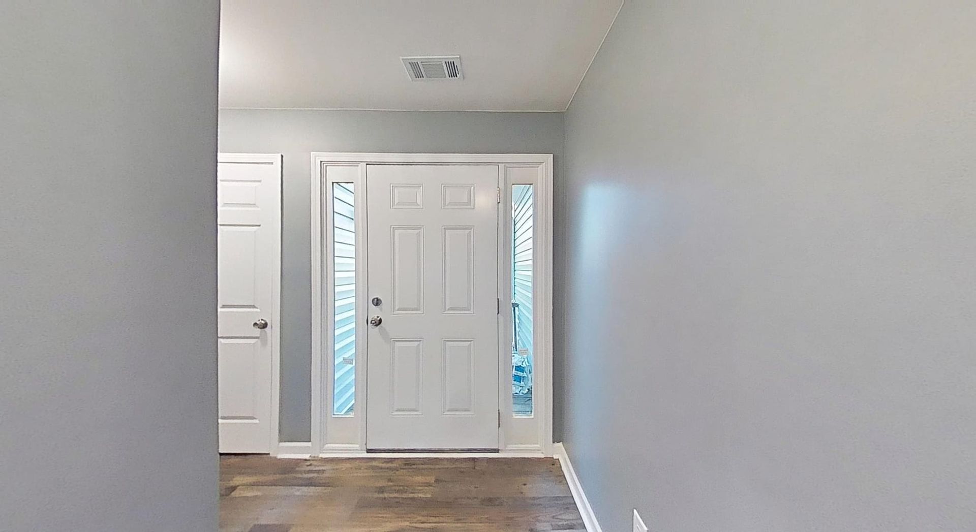 Restored entry hall with fresh paint and new fixtures after fire damage restoration