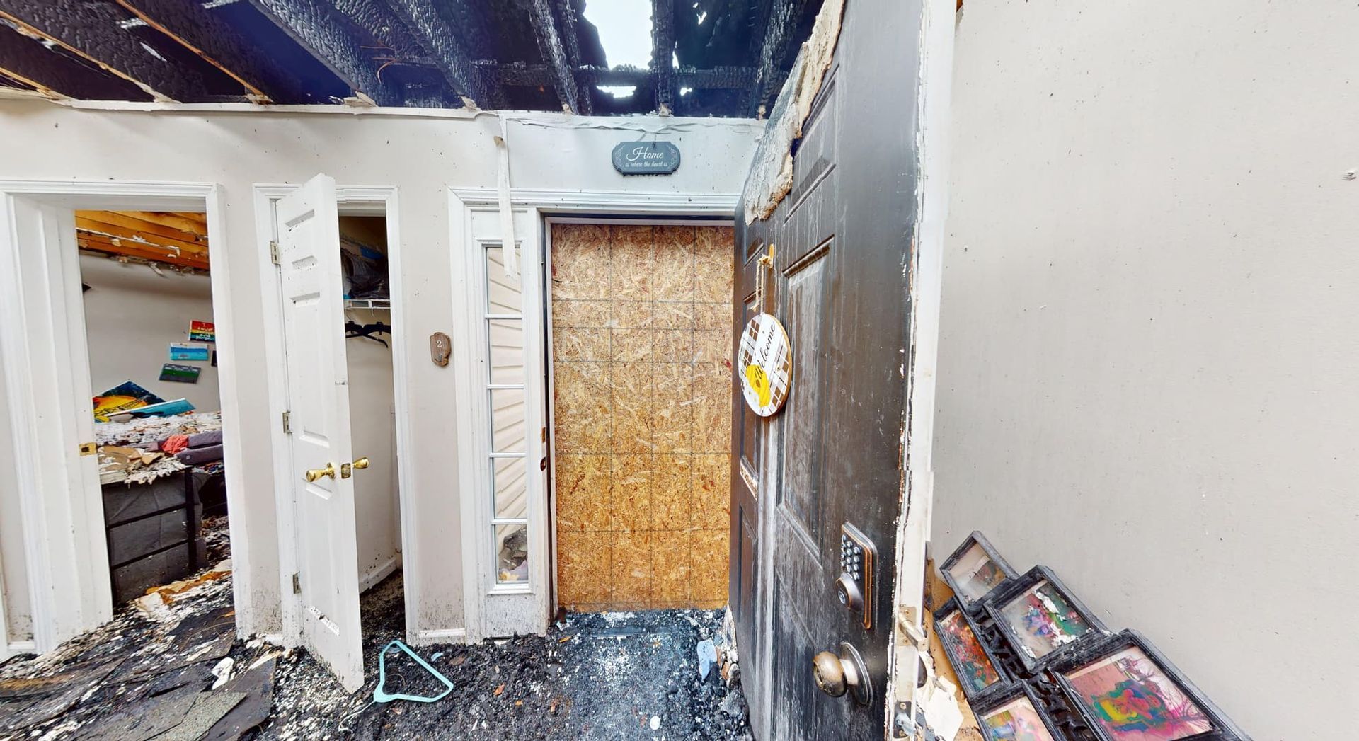 Fire damaged entry hall with blackened walls and ceiling before restoration in Loganville