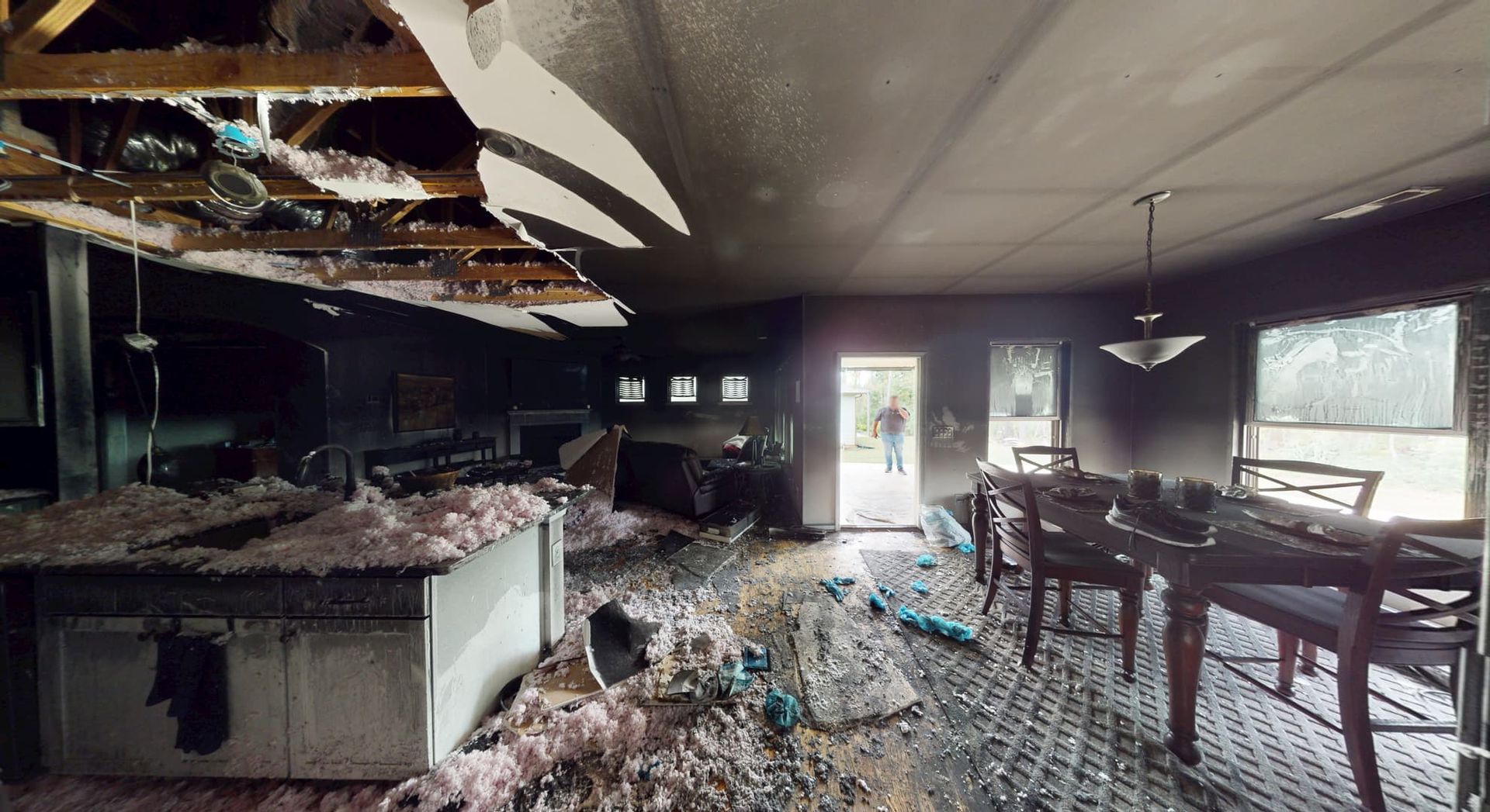 Kitchen area before fire restoration showing destroyed cabinets and appliances