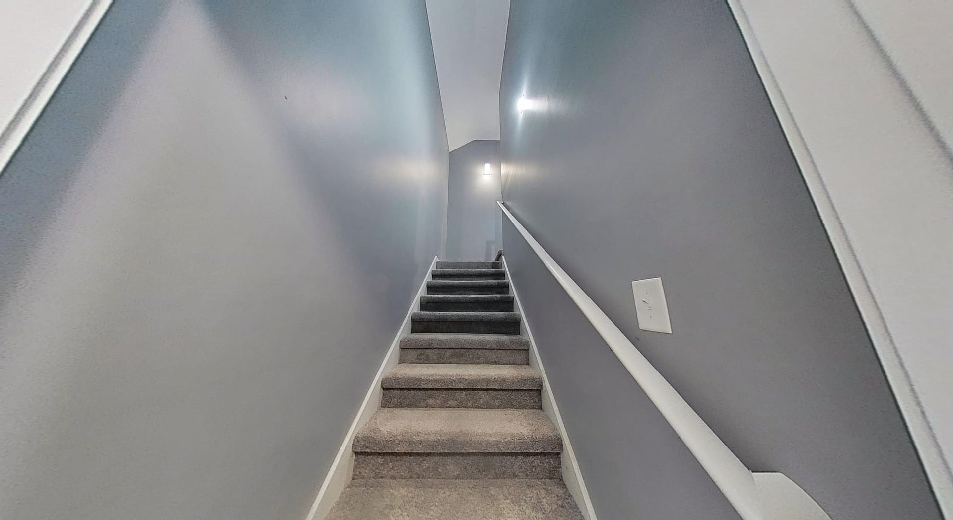 Rebuilt staircase with new railings and fresh paint after complete fire damage restoration
