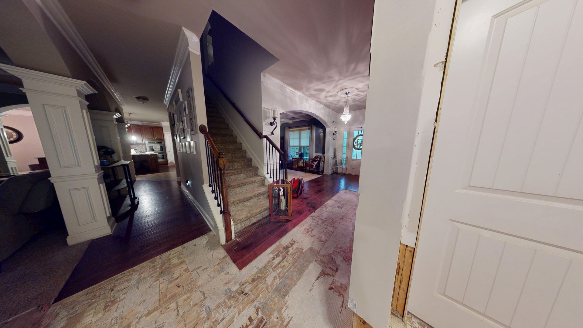 Hallway and staircase with flood water damage before restoration in a Palmetto home