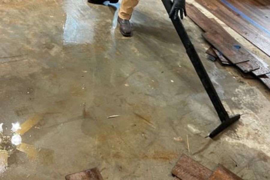 Professional flood cleanup crew performing water extraction from a home after a hurricane