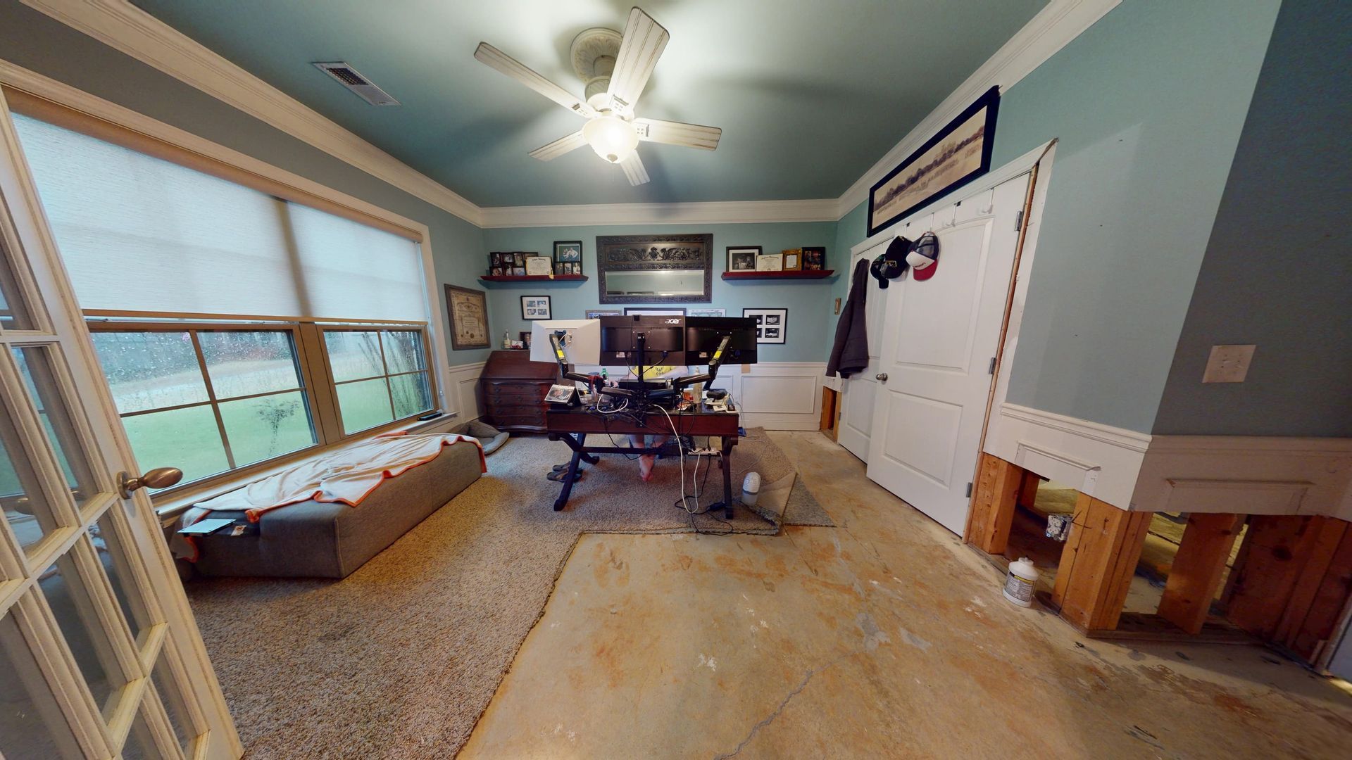 Home office with flooded and damaged flooring before restoration