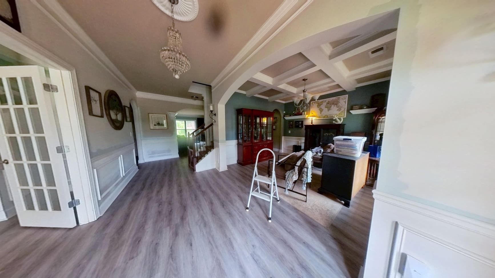 Restored dining room and hallway with new flooring after flood cleanup