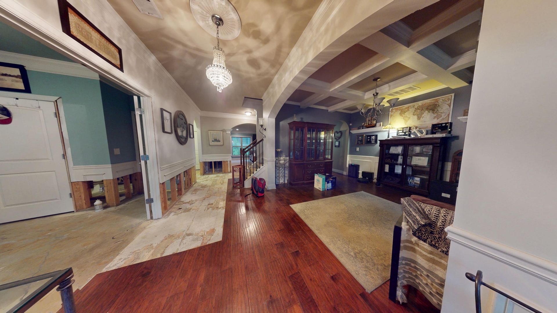 Dining room and hallway with flood water damage to the floor before restoration