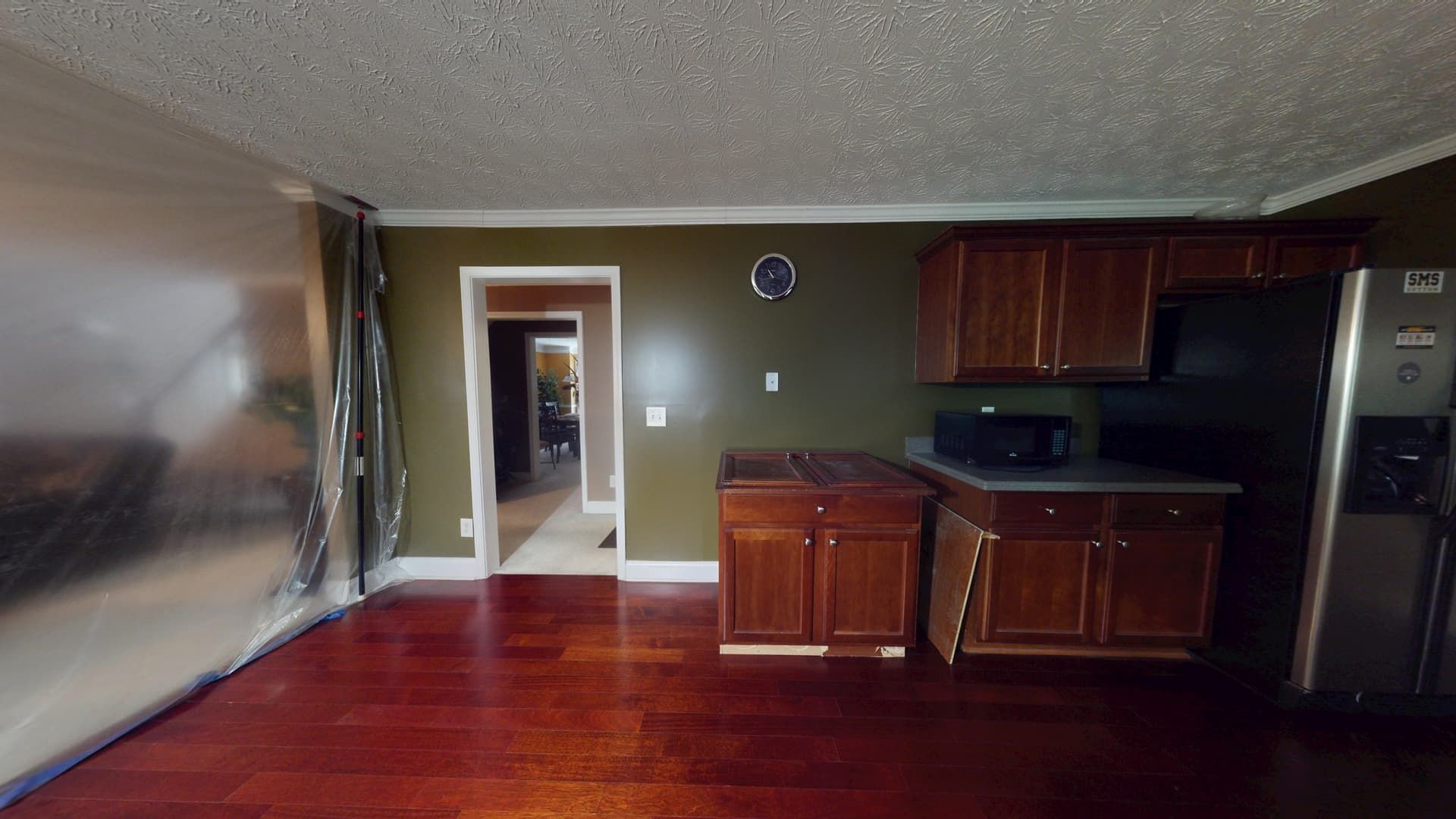 Kitchen flood damage in Stonecrest home showing standing water and damaged flooring