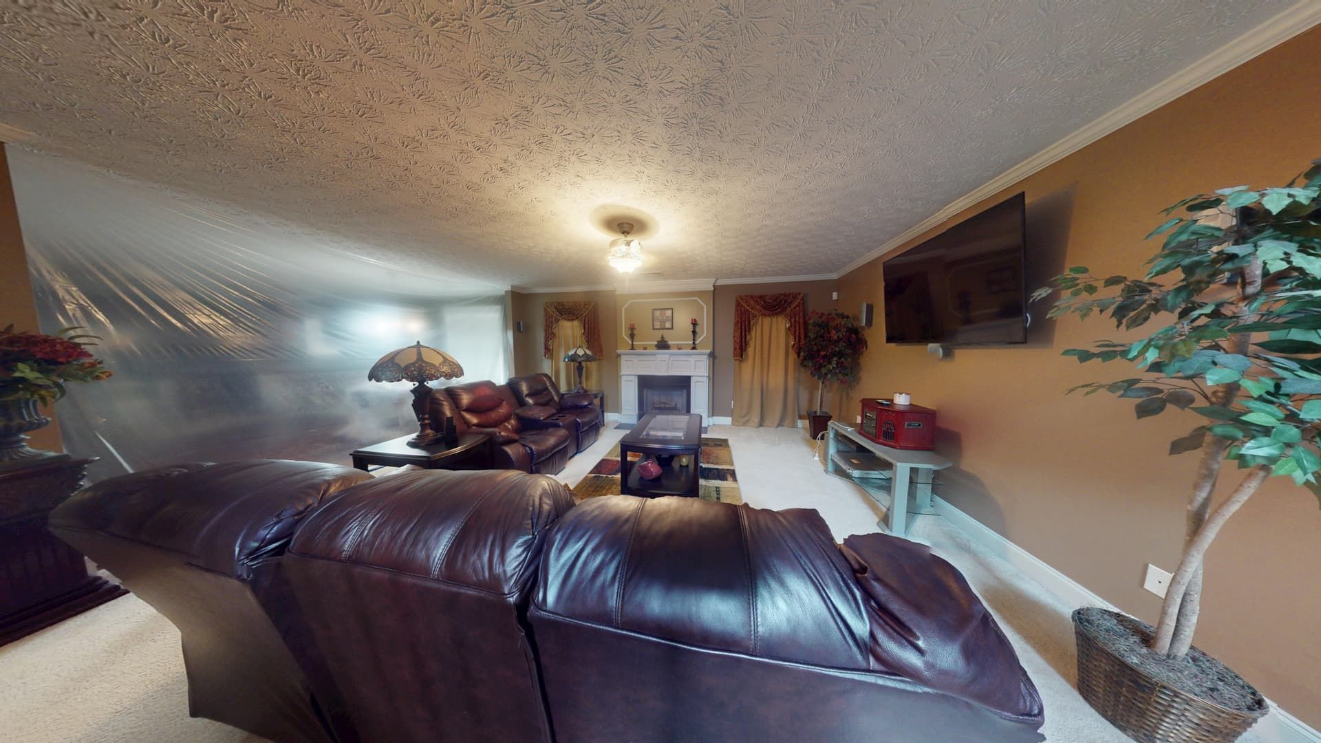 Water damage in Stonecrest living room before restoration showing saturated flooring and baseboards