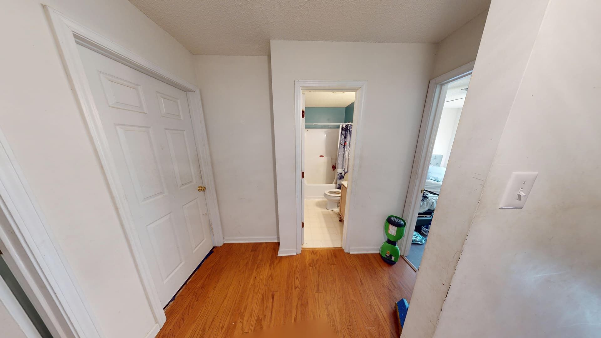 Damaged hallway ceiling with water staining and sagging drywall before repair