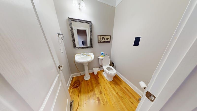 Guest bathroom with warped flooring from water damage