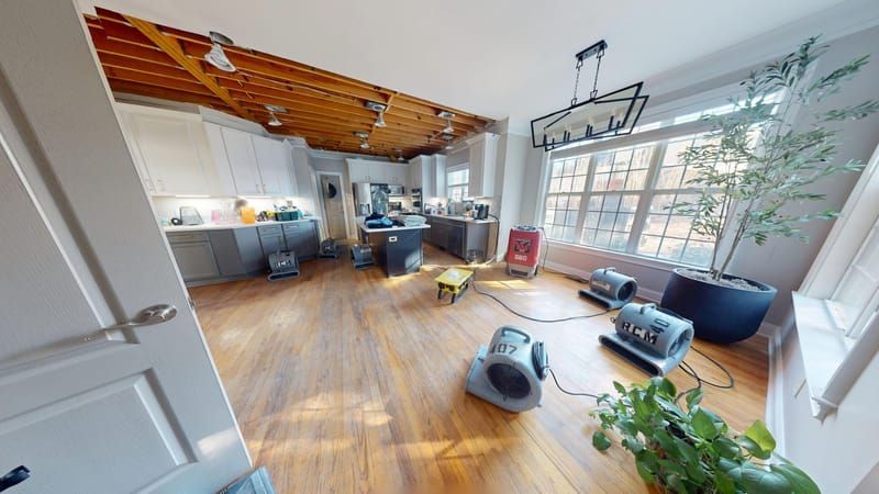 Kitchen with severe ceiling water damage and exposed beams