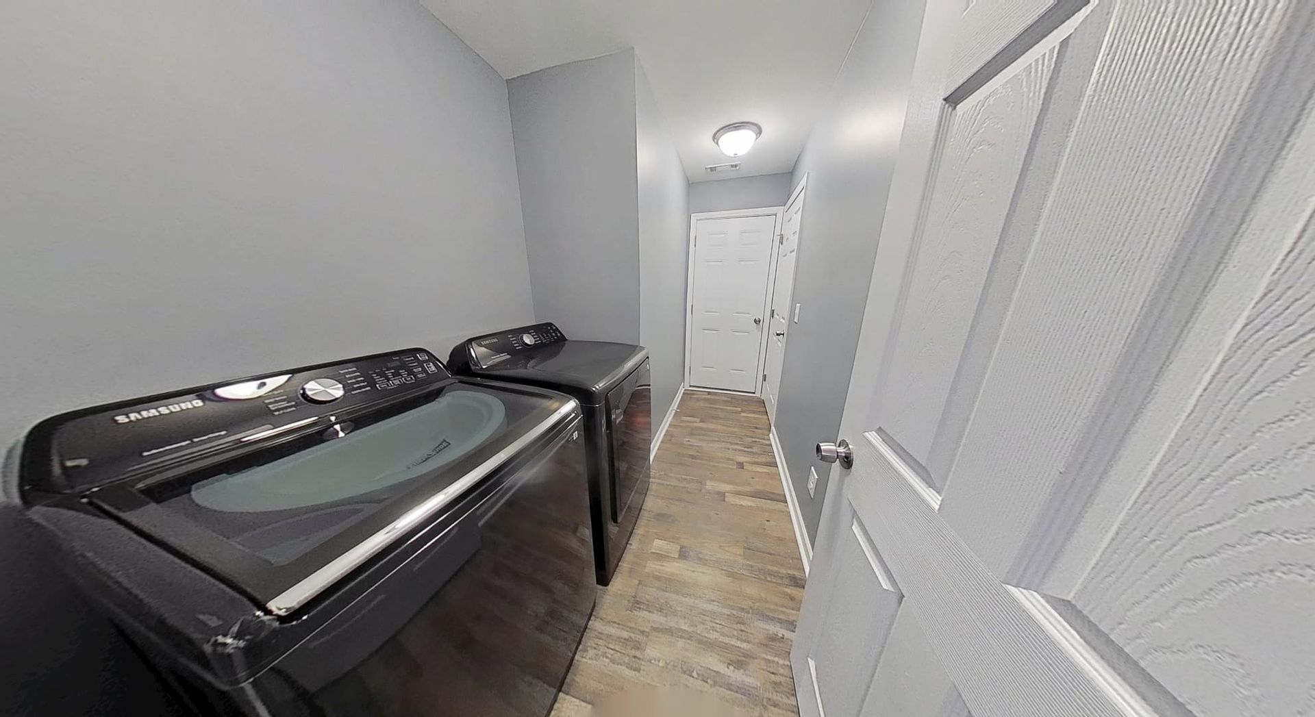 Restored laundry room with fresh walls and new fixtures after fire damage restoration