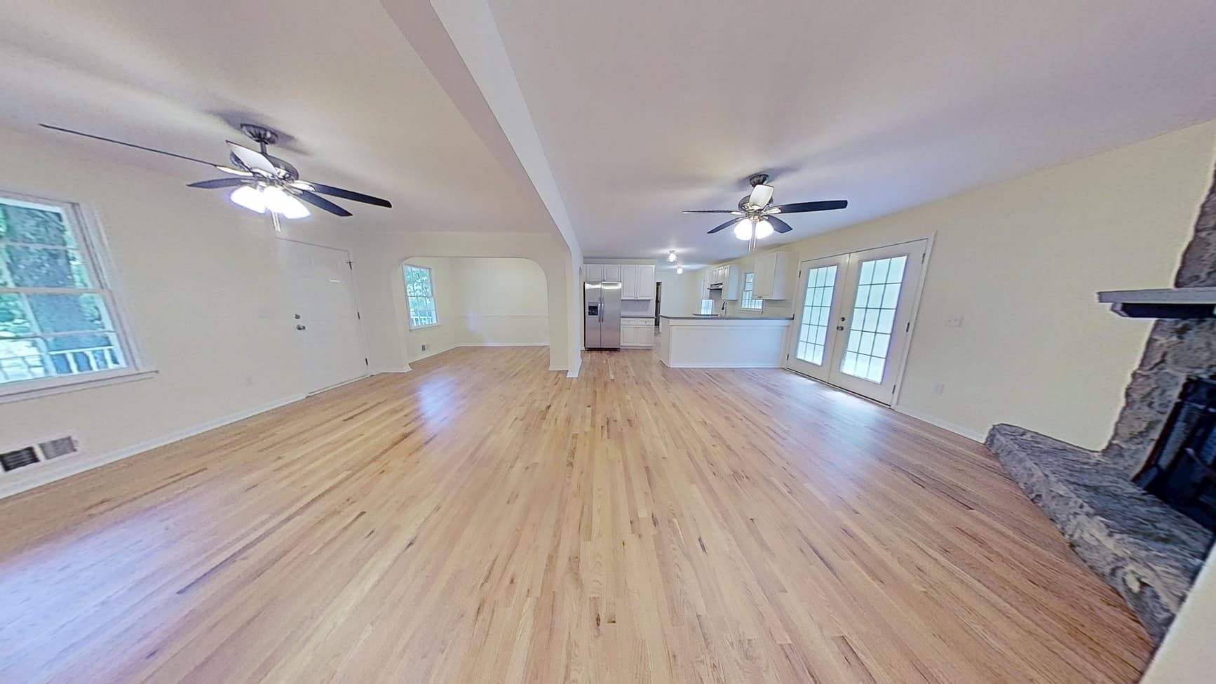 Restored open concept living room and kitchen after water damage repair
