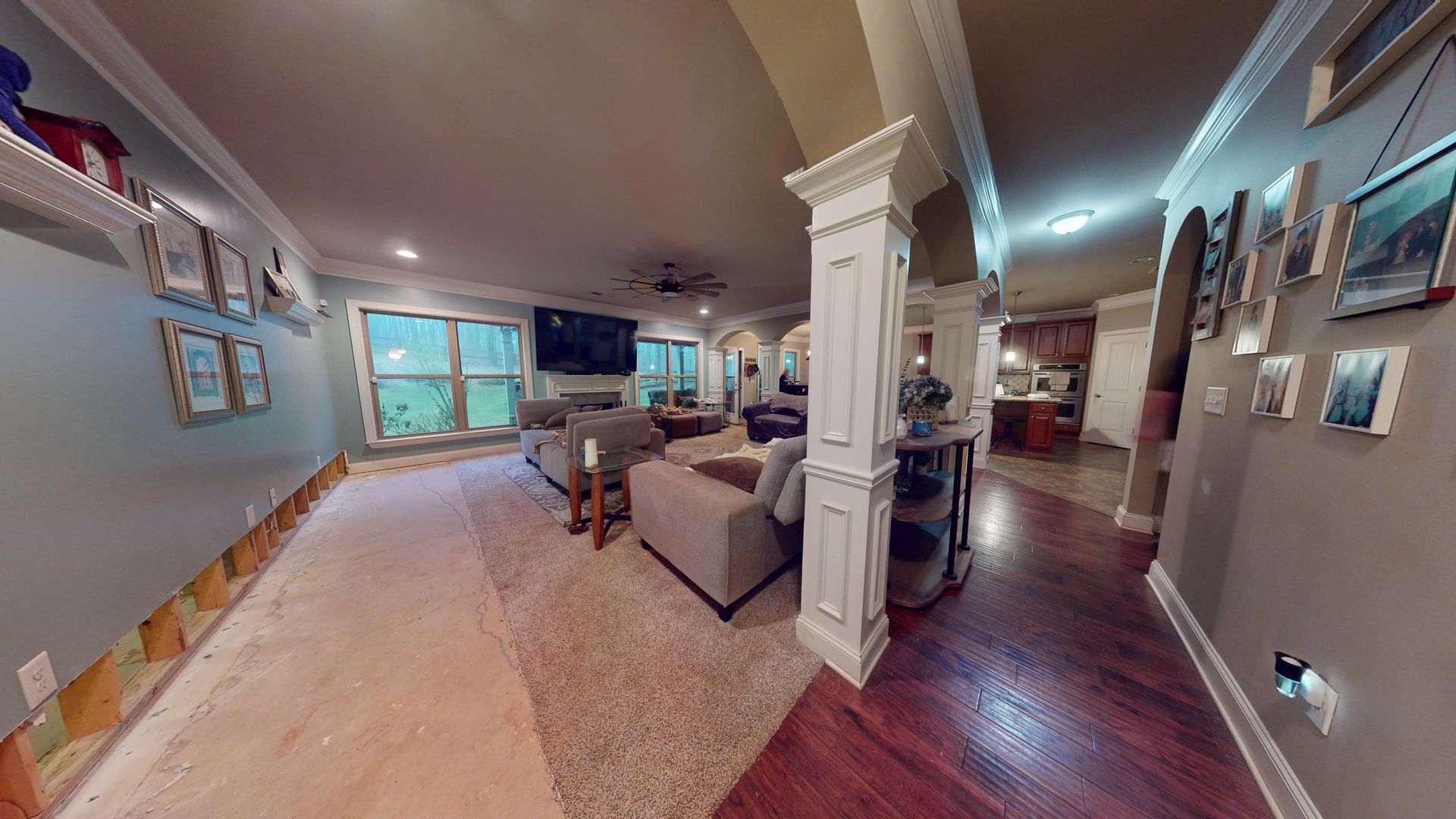 Living room with flood water damage to flooring before mitigation in a Palmetto home