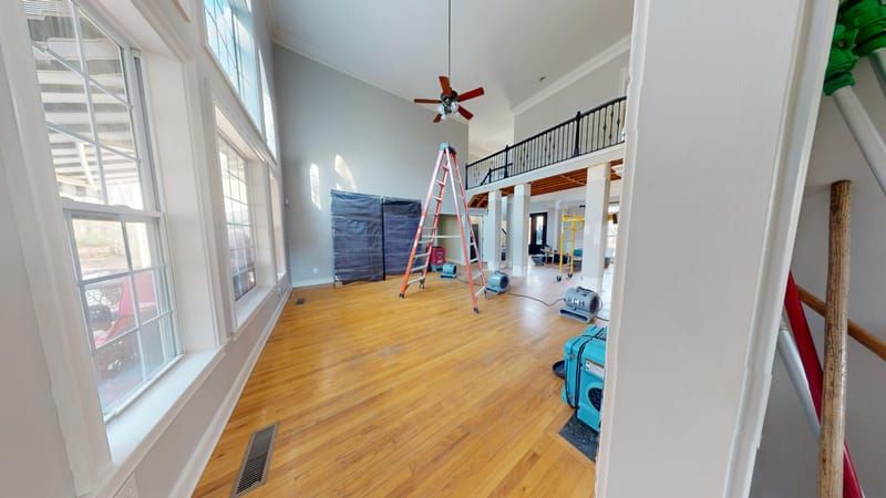 Living room with extensive water damage before restoration