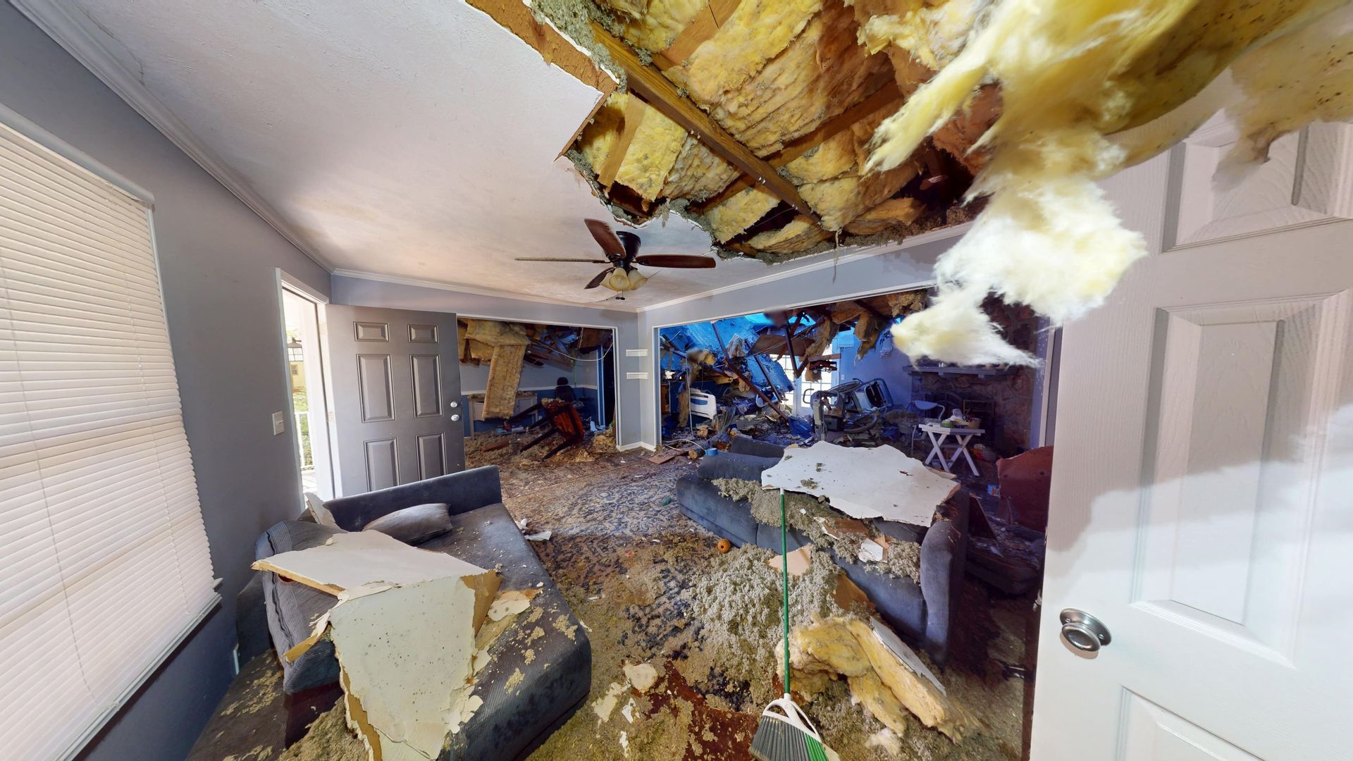 Living room water damage on walls and flooring before restoration in Stone Mountain
