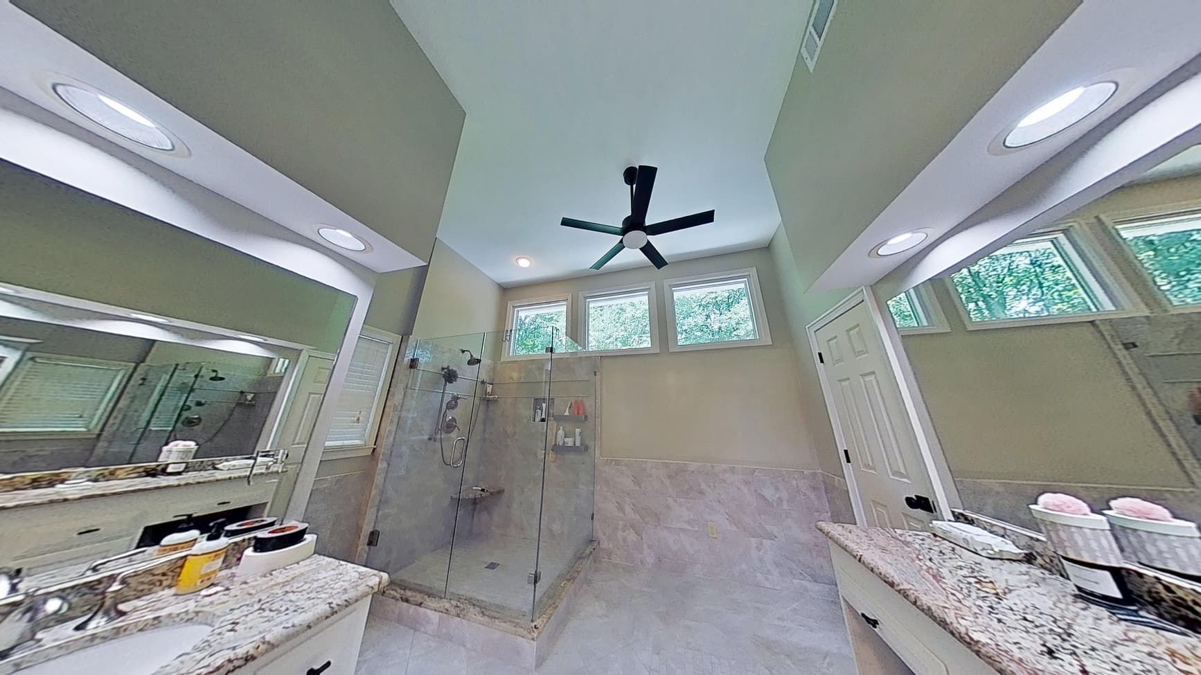 Restored master bathroom ceiling after roof leak water damage repair in Cumming
