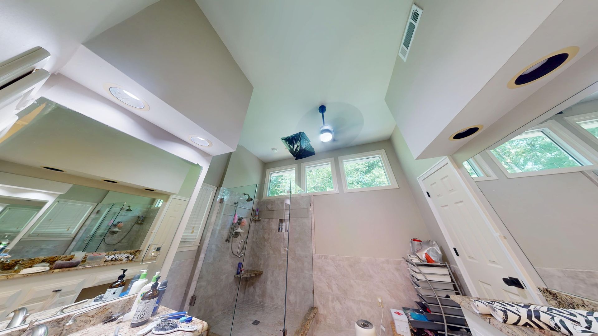 Master bathroom ceiling water damage from a roof leak in Cumming before restoration