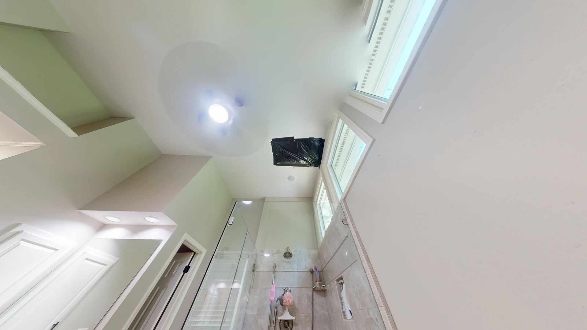 Water stained and sagging bathroom ceiling drywall from a roof leak before repair