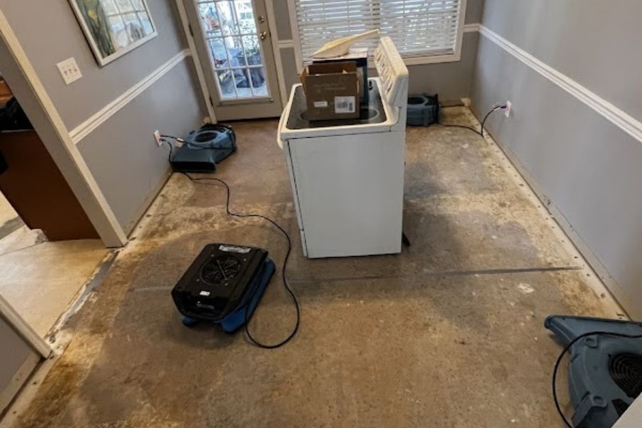IICRC-certified technician using moisture detection equipment during water damage assessment
