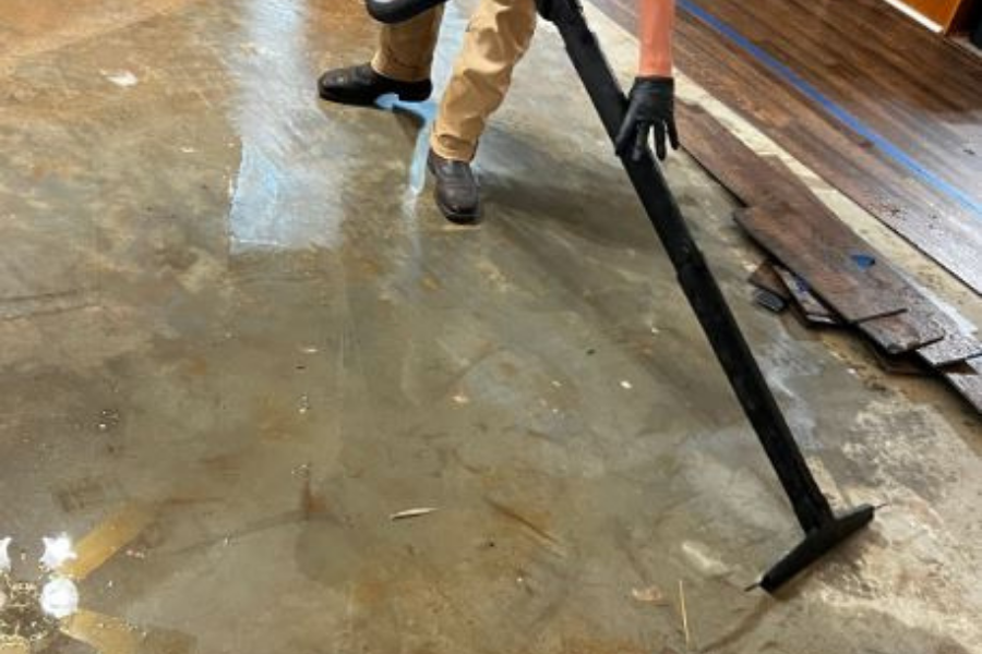 Professional water extraction equipment and floor removal during water damage restoration