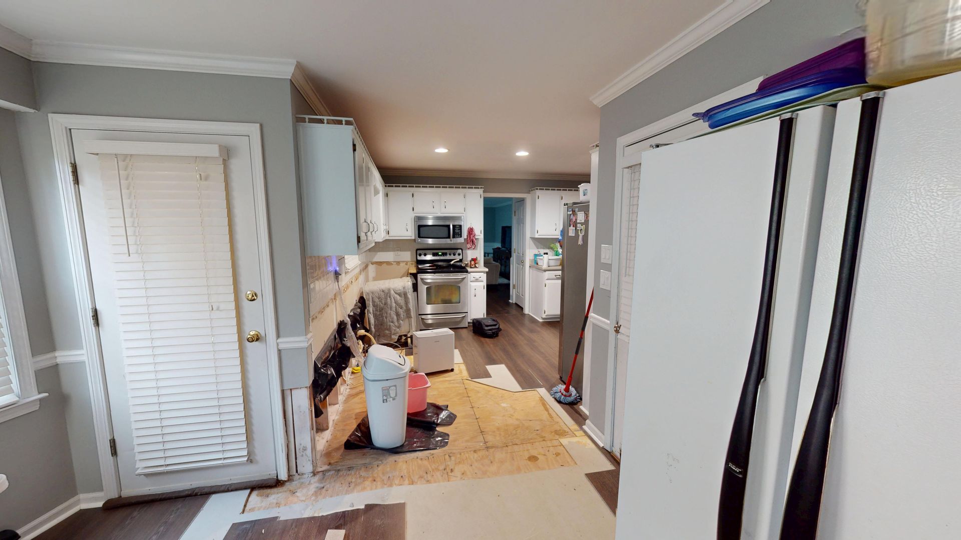 Side view of kitchen cabinets with water damage before restoration