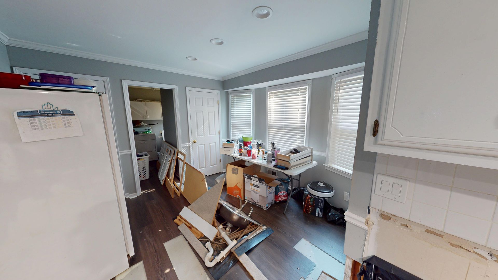 Kitchen storage space with water damage before restoration